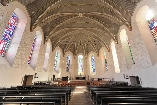 Speyer Cathedral, interior view of a church with wooden benches, high vaults and stained glass
