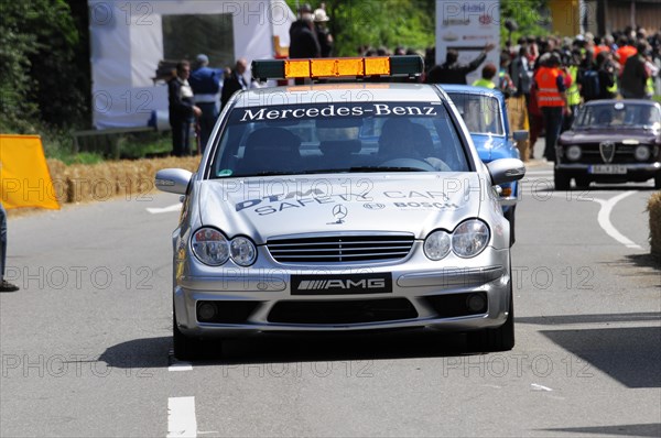 The white Mercedes-AMG safety vehicle on a race track surrounded by spectators, SOLITUDE REVIVAL