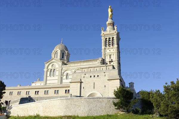 Church of Notre-Dame de la Garde, Marseille, Large historic church under a cloudless blue sky,