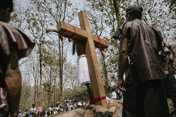Christian devotees takes part in a perform to re-enactment of the crucifixion of Jesus Christ