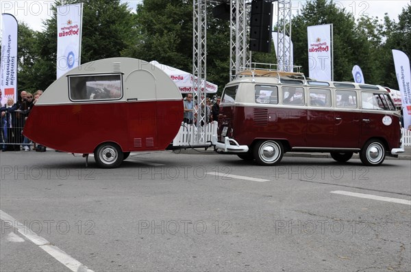 Side view of a VW bus with caravan in front of a crowd of spectators, SOLITUDE REVIVAL 2011,