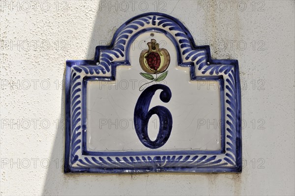 Solabrena, Blue and white ceramic house number with crown and ornaments on a wall, Andalusia,