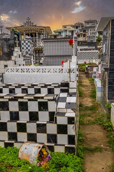 Famous cemetery, many mausoleums or large tombs decorated with tiles, often in black and white.