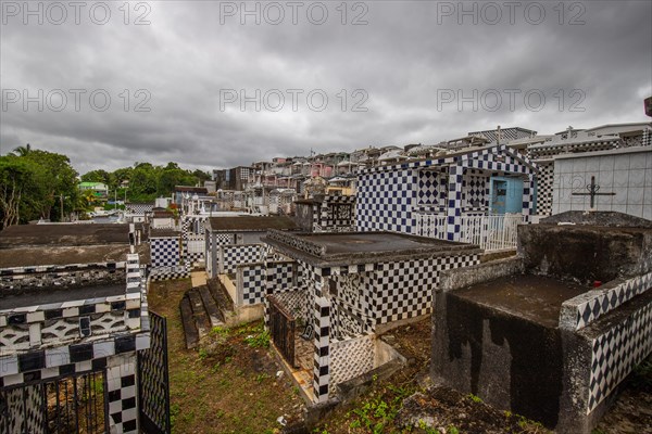 Famous cemetery, many mausoleums or large tombs decorated with tiles, often in black and white.