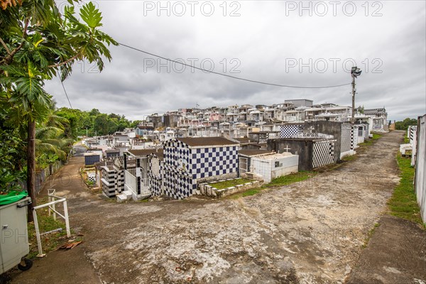 Famous cemetery, many mausoleums or large tombs decorated with tiles, often in black and white.