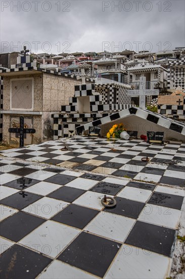 Famous cemetery, many mausoleums or large tombs decorated with tiles, often in black and white.