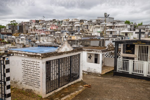 Famous cemetery, many mausoleums or large tombs decorated with tiles, often in black and white.