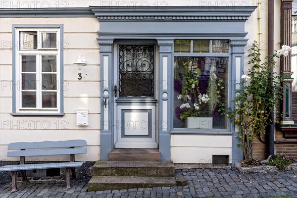 Historic shop around 1800, facade with bench and shop window, restored former restaurant and