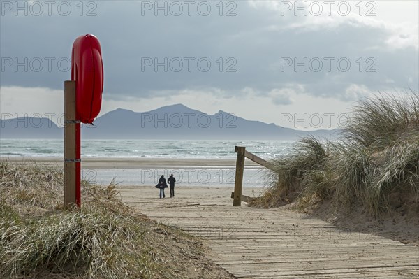 Life buoy, beach access, people, mountains, LLanddwyn Bay, Newborough, Isle of Anglesey, Wales,