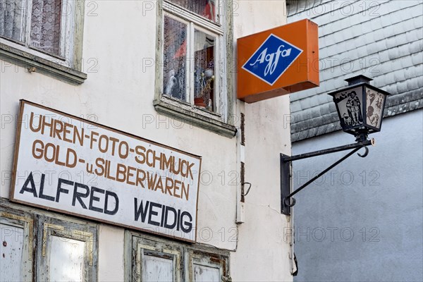 Cantilever sign, AGFA Film und Foto advertising sign, abandoned photo shop with watch shop,