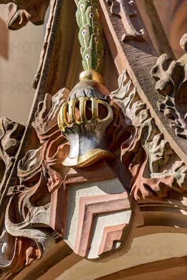 Coat of arms of the Lords of Eppstein with helmet and crest of peacock feathers above porch and