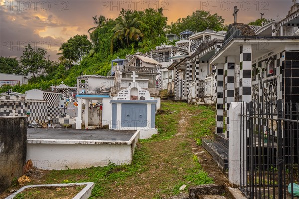 Famous cemetery, many mausoleums or large tombs decorated with tiles, often in black and white.