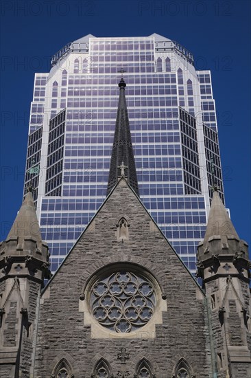 Old Christ Church Cathedral facade with rose window and modern architectural steel and blue tinted