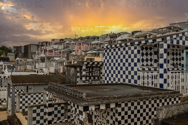 Famous cemetery, many mausoleums or large tombs decorated with tiles, often in black and white.