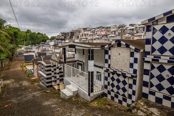 Famous cemetery, many mausoleums or large tombs decorated with tiles, often in black and white.