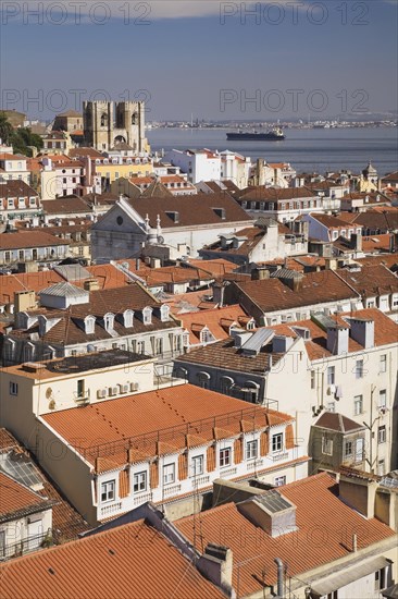 High angle view of buildings with traditional terracotta tiled rooftops in old Lisbon from Santa