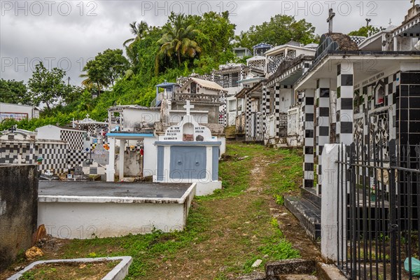Famous cemetery, many mausoleums or large tombs decorated with tiles, often in black and white.