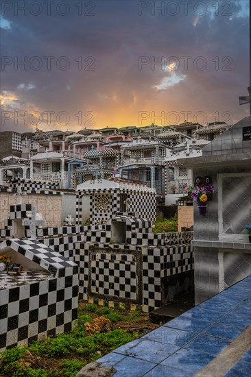Famous cemetery, many mausoleums or large tombs decorated with tiles, often in black and white.