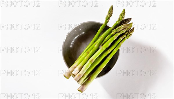 Stylish image of asparagus sticking out of a bowl against a white background, AI generated, AI