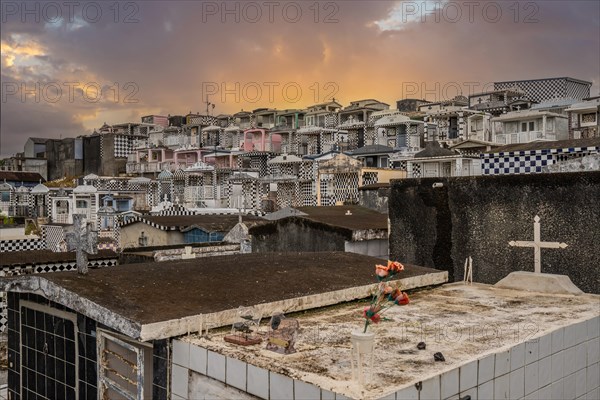 Famous cemetery, many mausoleums or large tombs decorated with tiles, often in black and white.