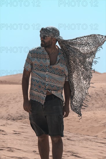 Portrait of tourist man with turban in summer in the dunes of Maspalomas, Gran Canaria, Canary
