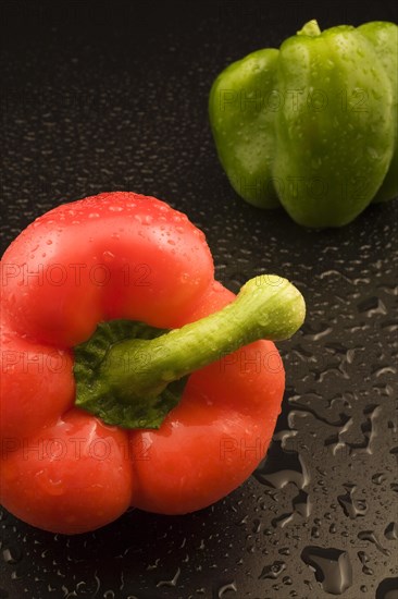 Close-up of freshly picked and washed red and green Capsicum annuum, Bell Peppers on black