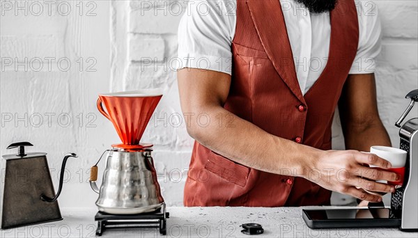 Unrecognizable Barista fashionista in an leather vest and white t-shirt apron brewing pour-over