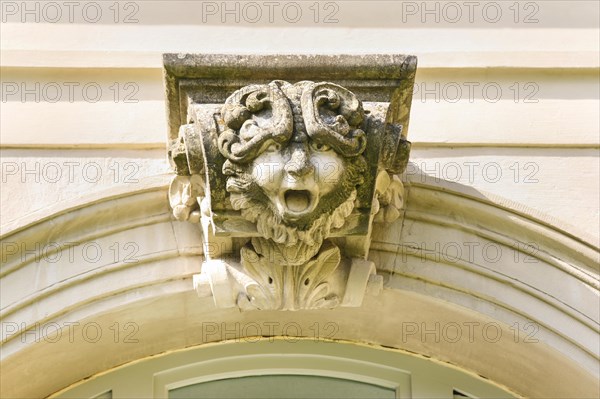 Mythical creature above archway, stone figure, face, Winnental Castle built in the 15th century by