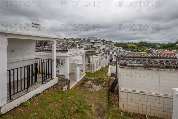 Famous cemetery, many mausoleums or large tombs decorated with tiles, often in black and white.
