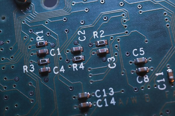 Close-up of blue lighted electronic computer circuit board with microchips and lines, Studio