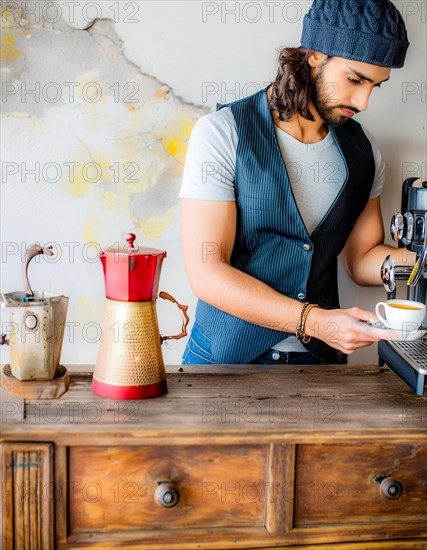 A barista prepares espresso at a vintage coffee machine on a rustic wooden counter, Vertical aspect