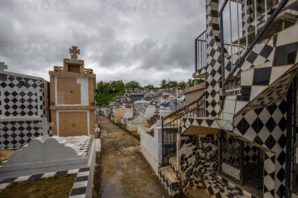 Famous cemetery, many mausoleums or large tombs decorated with tiles, often in black and white.