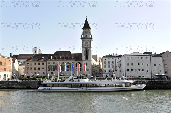 Ships on the river (Danube) in front of a town with a prominent church tower, Passau, Bavaria,
