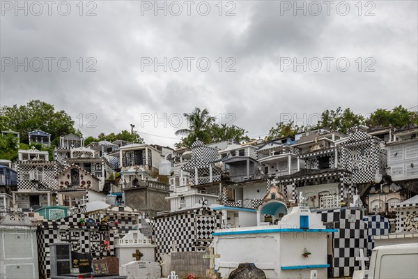 Famous cemetery, many mausoleums or large tombs decorated with tiles, often in black and white.