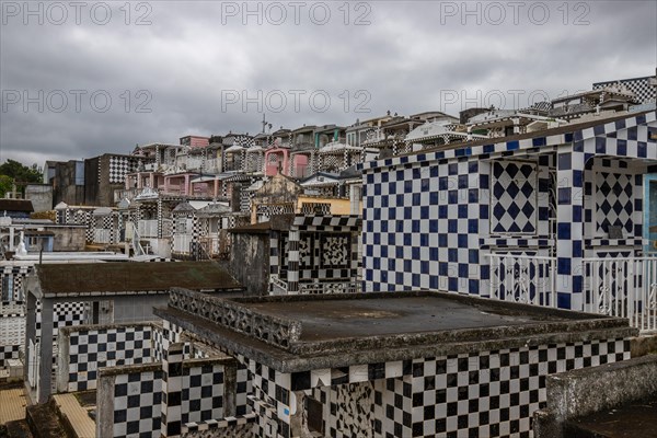 Famous cemetery, many mausoleums or large tombs decorated with tiles, often in black and white.