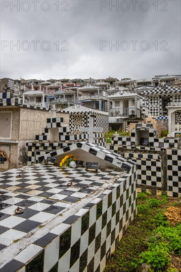 Famous cemetery, many mausoleums or large tombs decorated with tiles, often in black and white.