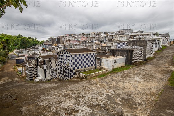 Famous cemetery, many mausoleums or large tombs decorated with tiles, often in black and white.