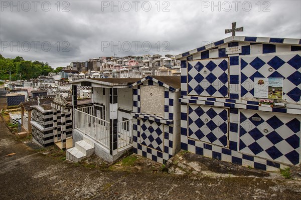 Famous cemetery, many mausoleums or large tombs decorated with tiles, often in black and white.