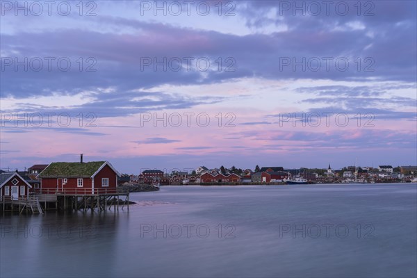 The village of Reine. Typical red wooden houses (rorbuer) on wooden stilts. At night at the time of