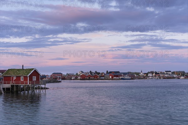 The village of Reine. Typical red wooden houses (rorbuer) on wooden stilts. At night at the time of