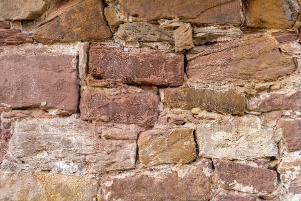 Wall made of sandstone, natural stone, quarry stone and mortar, background picture, old town,
