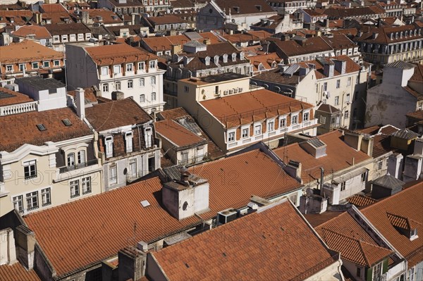 High angle view of buildings with traditional terracotta tiled rooftops in old Lisbon from Santa