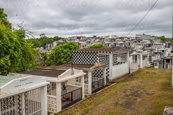 Famous cemetery, many mausoleums or large tombs decorated with tiles, often in black and white.