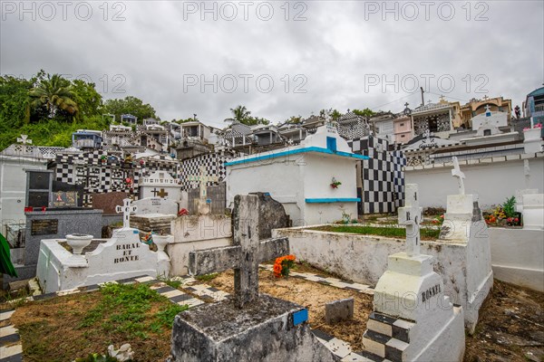Famous cemetery, many mausoleums or large tombs decorated with tiles, often in black and white.