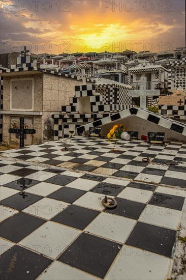 Famous cemetery, many mausoleums or large tombs decorated with tiles, often in black and white.