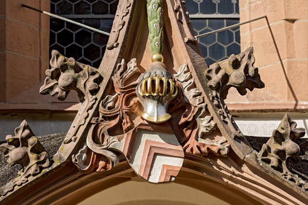 Coat of arms of the Lords of Eppstein with helmet and crest of peacock feathers above porch and