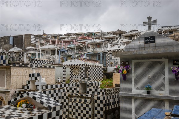 Famous cemetery, many mausoleums or large tombs decorated with tiles, often in black and white.