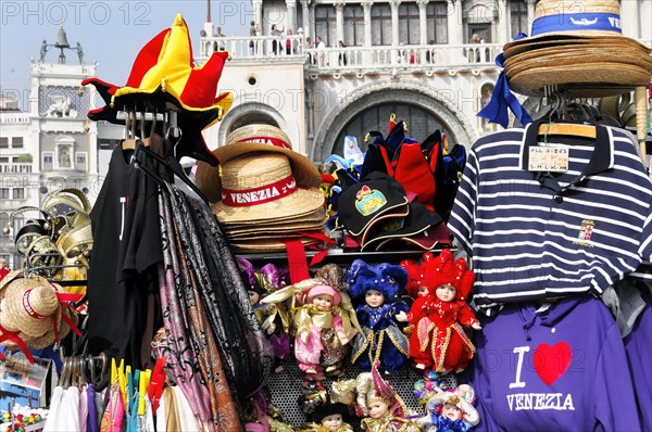 Colourful souvenir stall in Venice with hats, masks and striped shirts, Venice, Veneto, Italy,
