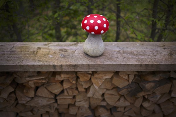 Fly agaric on a pile of wood, garden decoration, decoration, Stuttgart, Baden-Wuerttemberg,
