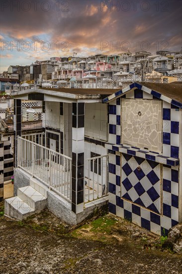Famous cemetery, many mausoleums or large tombs decorated with tiles, often in black and white.